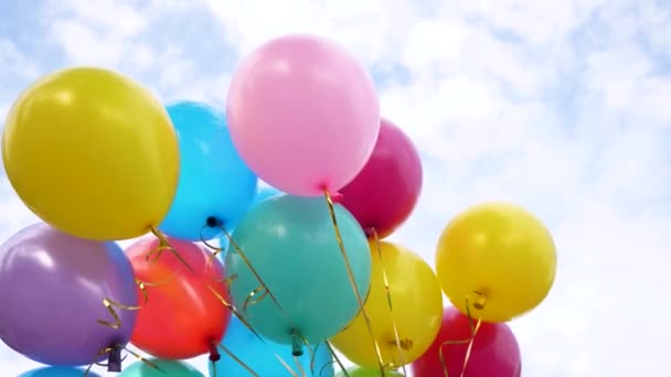 Beaux ballons multicolores dans le ciel bleu. concept de belles vacances. décorations de couleur à une fête . — Video