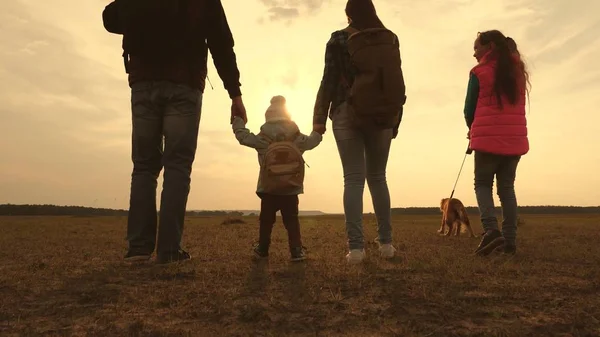 Vader, moeder, een klein kind en dochters en huisdieren toeristen. teamwork van een hechte familie. familie reist met de hond op de vlakte. Het concept van een sportieve familie vakantie in de natuur. — Stockfoto