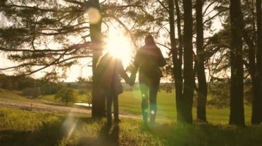 team work Hiker Girls Raising Her Hands Up, Celebrating Victory And Enjoying Scenery. teamwork mother and daughter on vacation travel through forest with backpack, raise their hands to top.