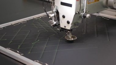 suni deri üzerinde otomatik makine nakış deseni. Robotik terzilik üretim hattında çalışır. Robot dikiş makinesi. bilgisayar dikiş makinesini kontrol eder. otomatik dikiş makinesi.