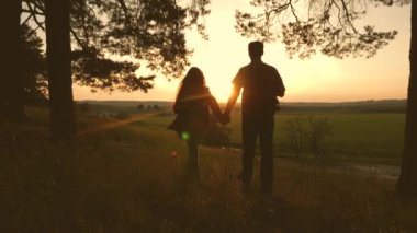 baba ve kızı seyahat, ormanda yürümek, gün batımında sahne keyfini çıkarın. Aşıklar sırt çantaları ile seyahat. Tatil seyahatlerinde mutlu bir turist ailesi. Romantizm. Yürüyüşçü Kız. Yavaş çekim.