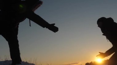 Erkekler ellerini tutup diğer her günbatımında zirveye uzanan yüksek karlı dağın zirvesine fethetmek için yardım. Ne zaman seyahat etmek soğuk doğal koşulları. Cesur için aşırı artışların