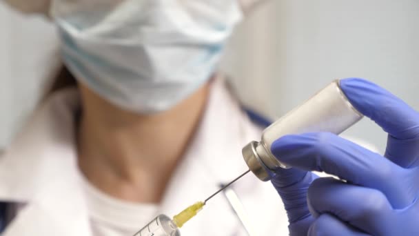 Vaccine for disease in the doctor hand. covid 19. nurse holds a syringe with medicine in his hand. the doctor prescribed an injection treatment. doctor is ready to give an injection to the patient. — Stock Video