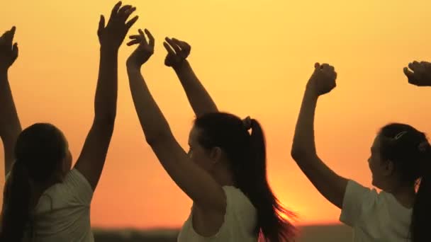 Gratis meisjes dansen vrolijk op een zomeravond bij zonsondergang. gezonde tieners die plezier hebben hun handen omhoog steken. viering in de open lucht. Vier een zomerdag op een strandfeest — Stockvideo