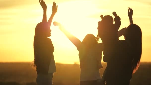 Happy family mom, daughters, children, dancing at family party. outdoor celebration. Celebrate a summer day with a beach party. healthy teenagers happily raise their hands up. holiday in nature — Stock Video