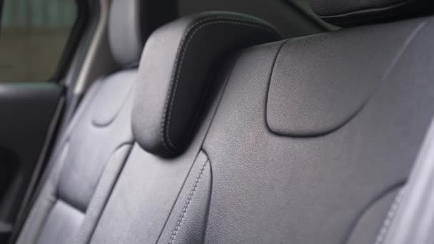 Luxury leather seats in car. beautiful leather car interior design. Black leather seat covers in the car. artificial leather rear seats in the car. Slow motion — Stock Video