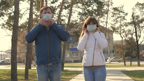 건강 한 남녀가 거리에서 보호용 마스크를 쓰고 있고, 괜찮아 보 입니다. 자유 로운 사람들은 바이러스를 위해 의료용 마스크를 쓰고 있습니다. 건강과 안전의 개념 대유행성 코로나 바이러스, 코로나 바이러스 N1H1, 바이러스 보호 — 스톡 사진