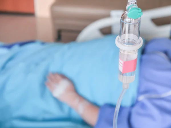 Selective focus Infusion bottle with IV, patient in hospital —  Fotos de Stock