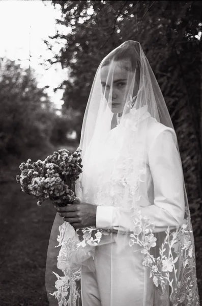 Beautiful bride in a white wedding costume. field, corn white woman boquet veil