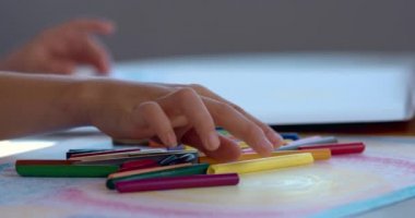 close-up footage of teen girl drawing at home