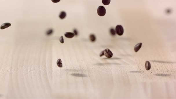 Brown Coffee Beans Falling Wooden Table Slow Motion — Stock Video