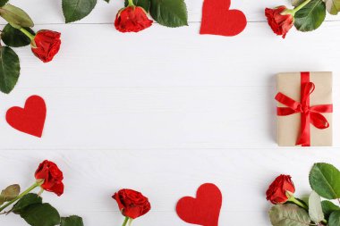 Bir buket kırmızı gül, hediye ve beyaz ahşap masa kalpler. Kavram kadın gün ya da St. Valentine. Alanı, düz yatıyordu kopyalama.