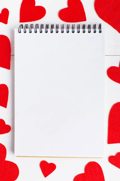 Notepad and red heart on white background. Place for text, copy space.