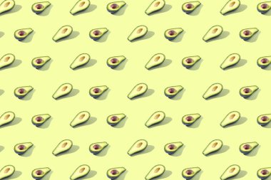 Birçok Yarım avokado, desen, banner. İşlenecek parçanın parlak arka plan, pastel sarı renk.