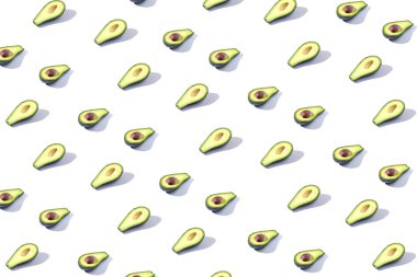 Birçok Yarım avokado, desen, afiş. Parlak arka plan, beyaz renk tedarik.