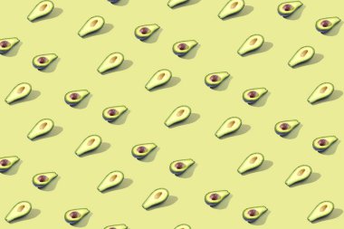 Birçok Yarım avokado, desen, banner. İşlenecek parçanın parlak arka plan, pastel sarı renk.