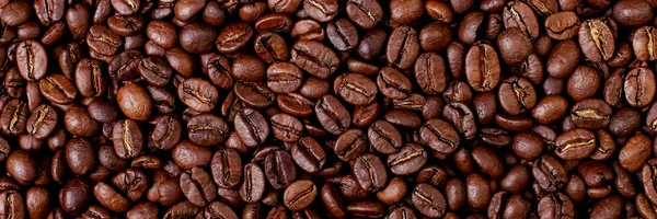 Aroma roasted coffee beans, brown background. Beans close up.