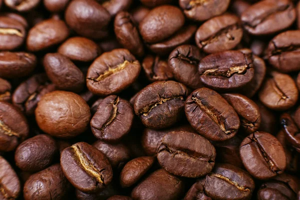 Aroma roasted coffee beans, brown background. Beans close up.