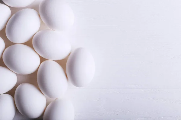 White eggs pattern, on wooden table.