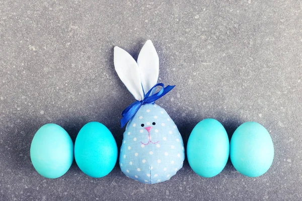 A number painted eggs, including two handmade Easter bunny, blue and pink.
