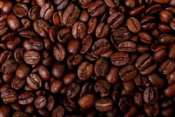 Aroma roasted coffee beans, brown background. Beans close up.