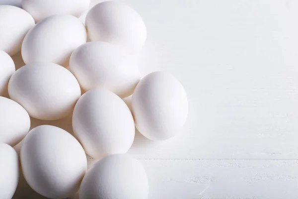 White eggs pattern, on wooden table.