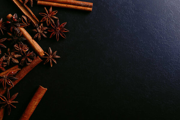 Spices sticks cinnamon and star anise on old table. Rustic dark background, aroma close-up, macro.