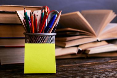 Defter, kitap açın ve kalemler tebeşir tahtası arka plan üzerinde koyu ahşap masa üzerinde durmak. Okulda, etiket kopya alanı bilgi öğrenme.