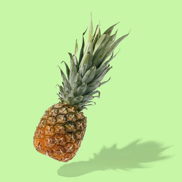 Pineapple flies in the air on bright background creative layout, — Stock Photo, Image