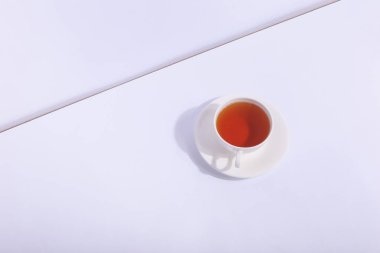 Seramik bardak çay, beyaz bir arka plan ile. Sert gölgesinde 