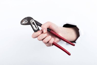 Kağıt, bir delikten el tutar evrensel bir İngiliz anahtarı. Beyaz arka plan üzerinde izole.