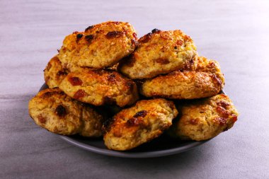 Baked cottage cheese and oatmeal cookies with raisins. Healthy nutrition, diet food.