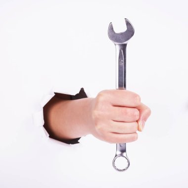 Bir kızın elinde bir anahtar. Sert çalışma sembolü, feminizm ve işgücü günü. Beyaz arka planda izole et.
