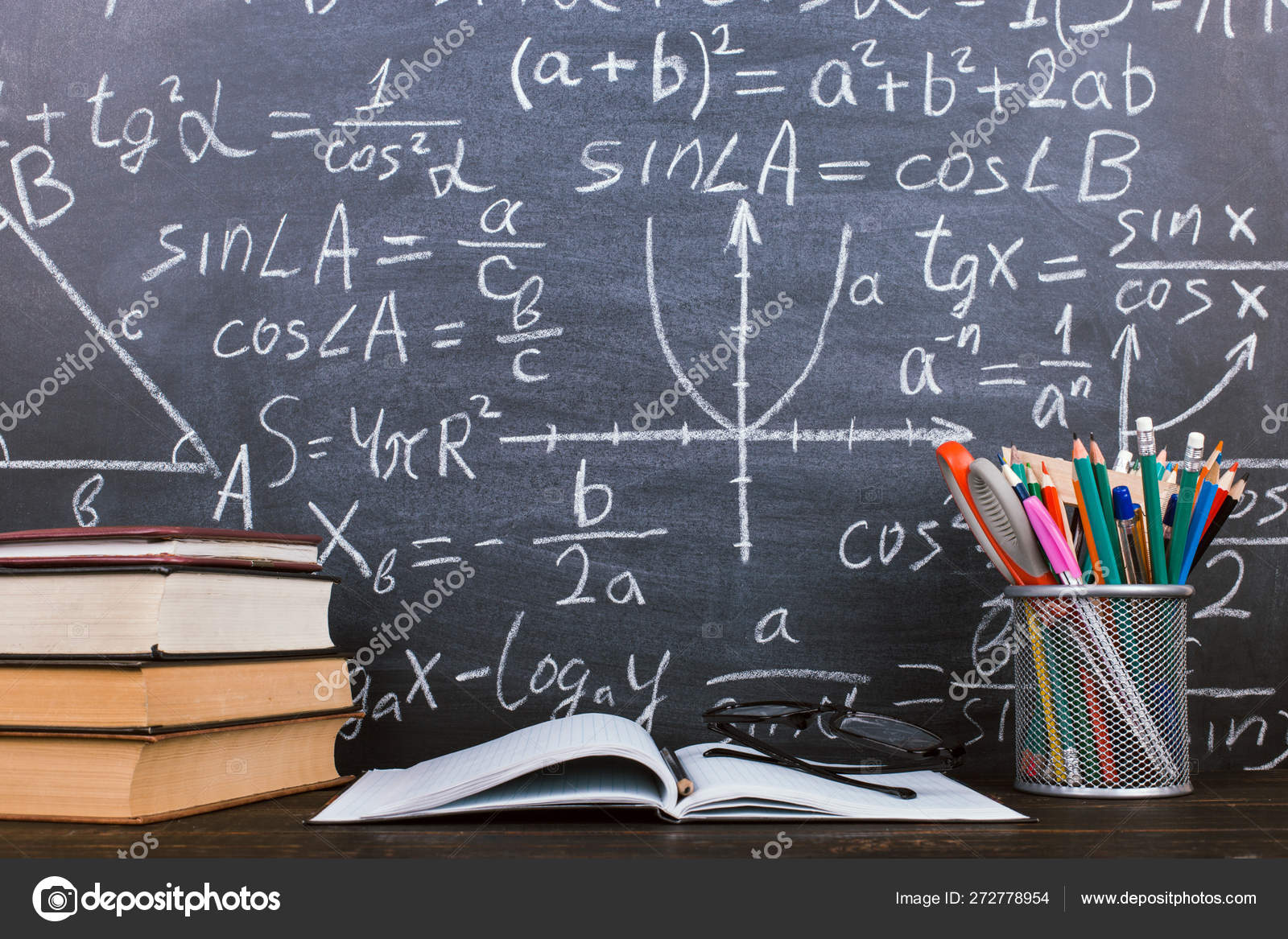 Books And Stand For Pens On A Wooden Table Against The Background Of A Chalk Board With Formulas Teacher S Day Concept And Back To School Stock Photo Image By C Maverick Pl