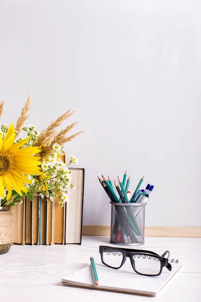 Teacher\'s day holiday greeting icon. Education knowledge concept. Wooden chalk board frame and vase bouquet on table empty copy space.