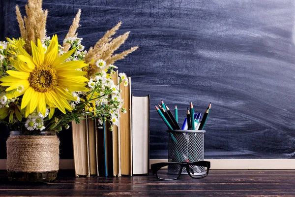 Teacher\'s day holiday greeting icon. Education knowledge concept. Wooden chalk board frame and vase bouquet on table empty copy space.