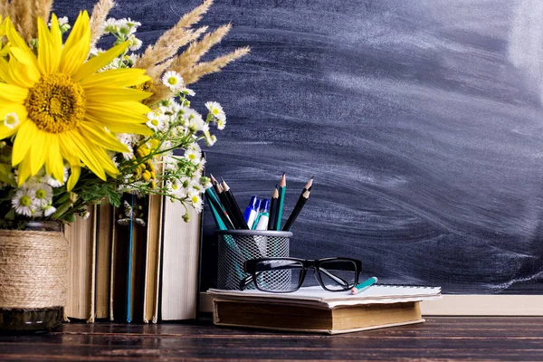 Teacher\'s day holiday greeting icon. Education knowledge concept. Wooden chalk board frame and vase bouquet on table empty copy space.