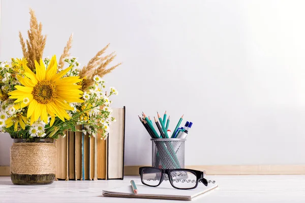 Teacher\'s day holiday greeting icon. Education knowledge concept. Wooden chalk board frame and vase bouquet on table empty copy space.