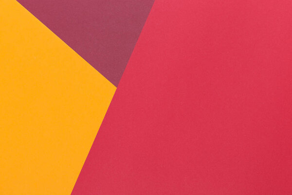 Paper yellow, burgundy, red empty background, geometrically located. Color blank for presentations, copy space.