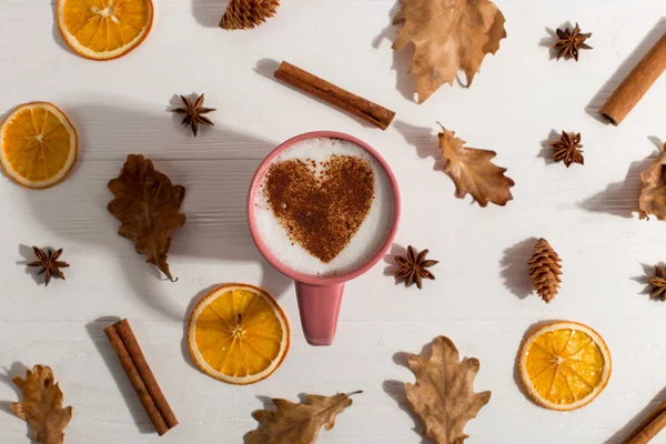 Dry yellow leaves, spice, coffee with heart pattern on the table, good morning is the best start day. Autumn mood background, copy space.