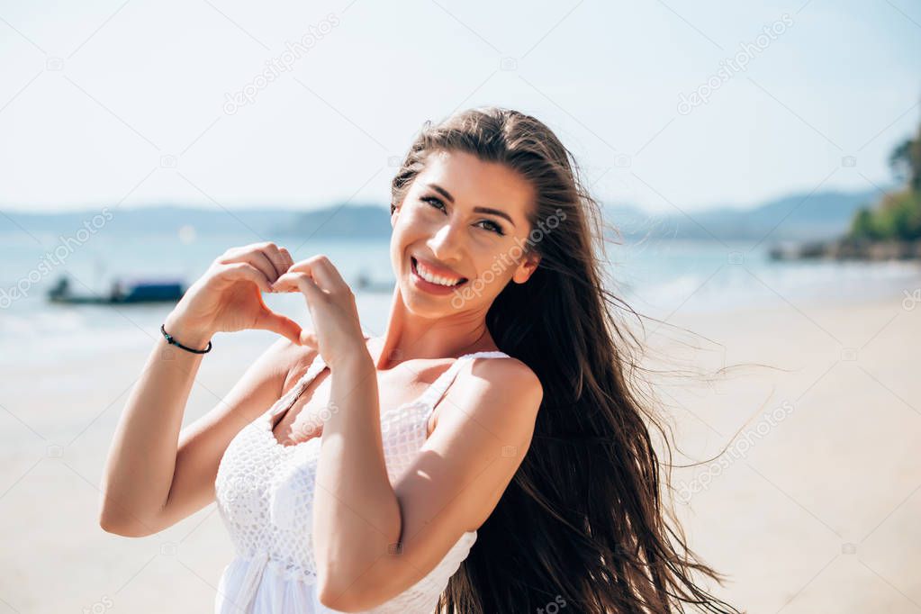 Smiling pretty woman enjoying at summer beach