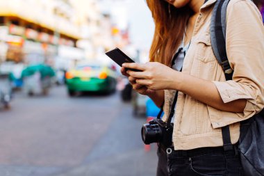 Sokak pazarında bir cep telefonu kullanarak genç turist