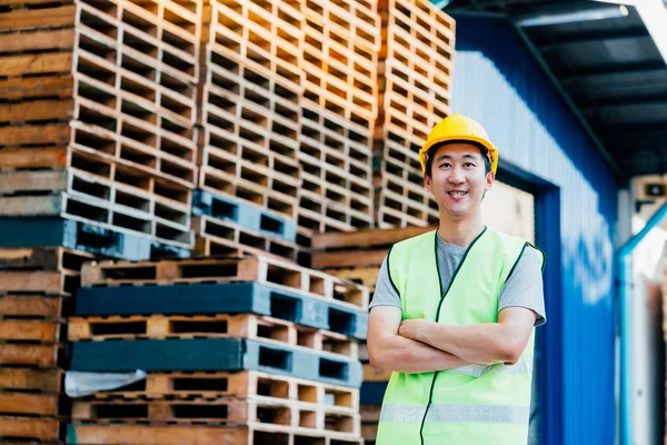 Warehouse and logistics industrial worker smiling with arms crossed