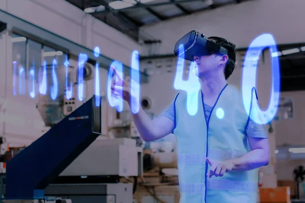 Factory engineer wearing VR goggle touching in Industrial 4.0 text on virtual reality