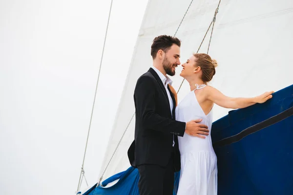Couple of young people kissing on yacht