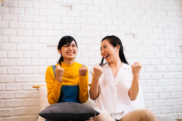 Excited Asian females watching TV — Stock Photo, Image