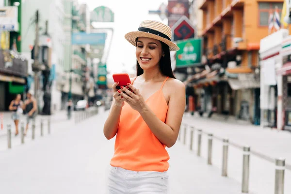 Happy and excited Hispanic girl traveler laughing wear summer clothes with hat in Asia. — Stock Photo, Image