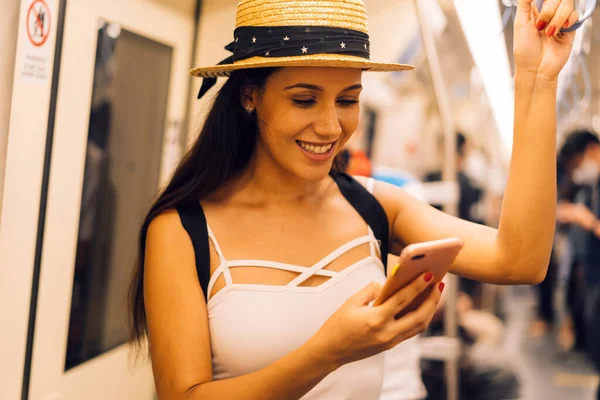 20s Hispanic girl passenger commuting on public transportation and reading on cellphone. — Stock Photo, Image