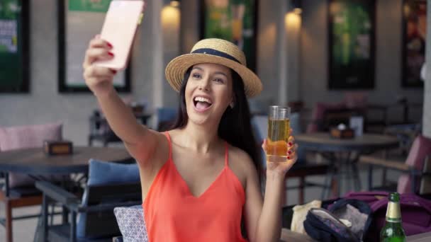 Portrét mladé brunetky, jak fotí selfie z mobilu v hospodě — Stock video