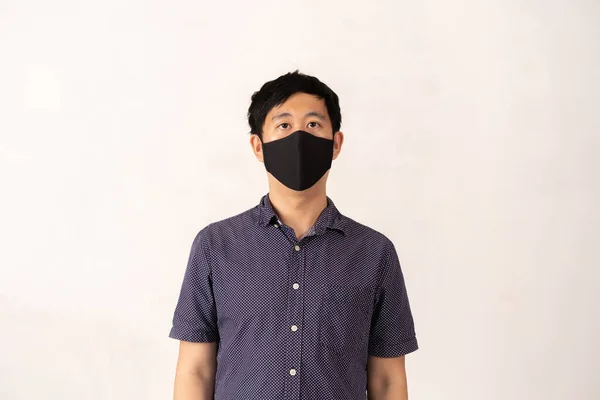 Asiático hombre usando cara máscara frente cámara, estudio disparo — Foto de Stock